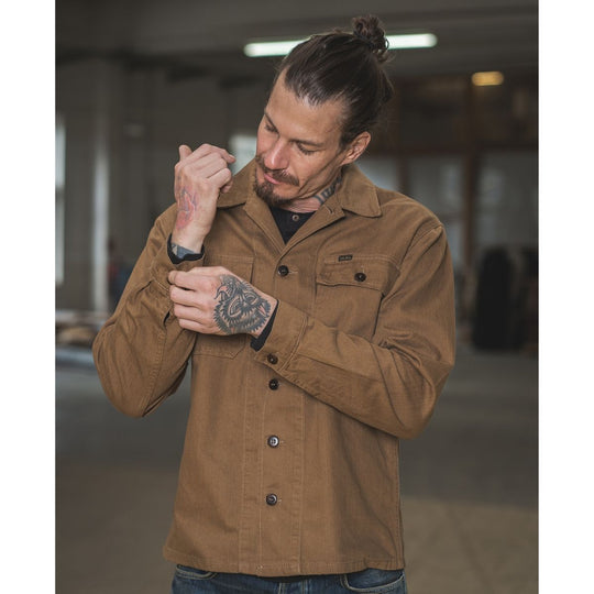 Pike Brothers 1962 OG-107 shirt brown men’s lifestyle image adjusting cuff showing fit and sleeve detail