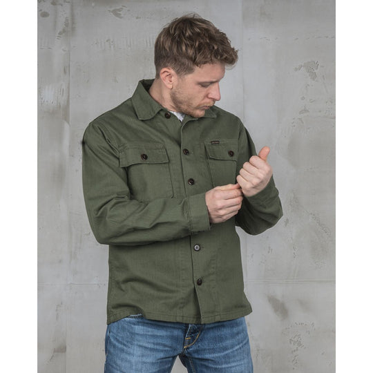 Pike Brothers 1962 OG-107 shirt olive men’s lifestyle image adjusting cuff showing sleeve fit and detailing