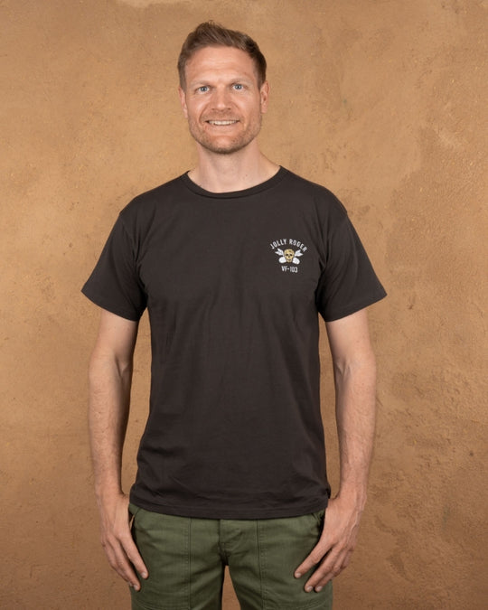 Model wearing Pike Brothers 1969 Jolly Roger Tee in Black with olive cargo pants – front view