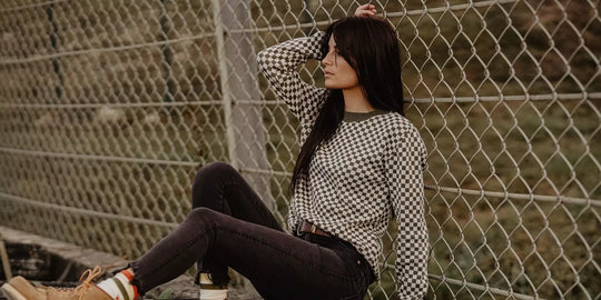 Model wearing the Wildust Sisters Vintage Racing Jumper in Khaki in an outdoor lifestyle setting