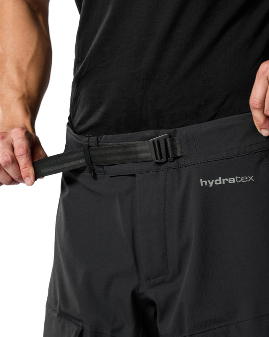 Close-up of waist adjustment strap on REV’IT Component 3 H2O pants in black