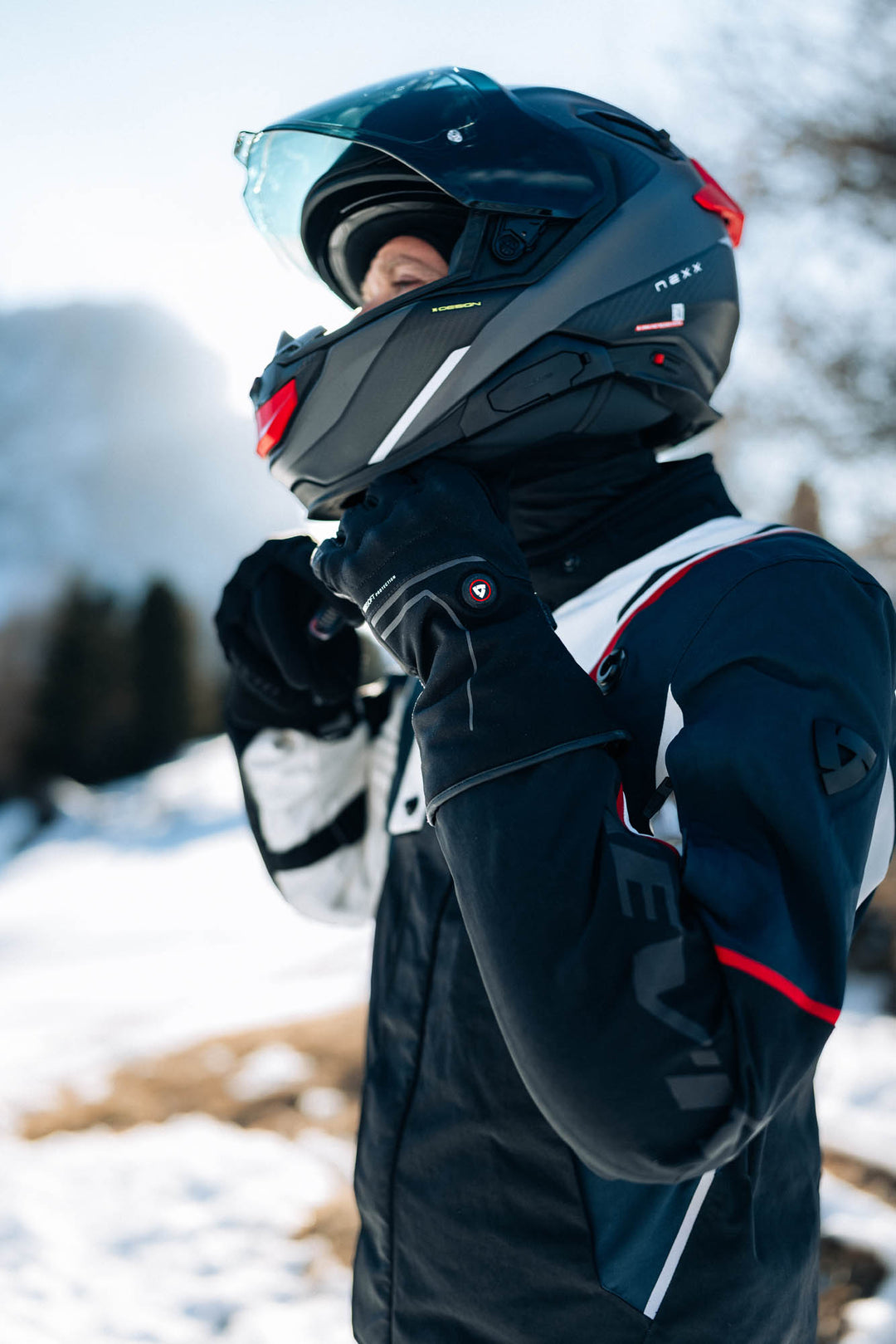 REV’IT! Freedom H2O Heated Gloves worn by rider in snowy conditions.
