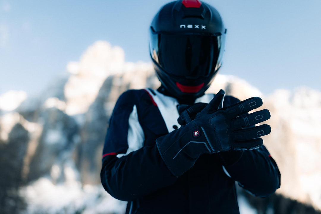 Model wearing REV’IT! Liberty 2 H2O Men’s Heated Motorcycle Gloves in black, front view in snowy conditions.
