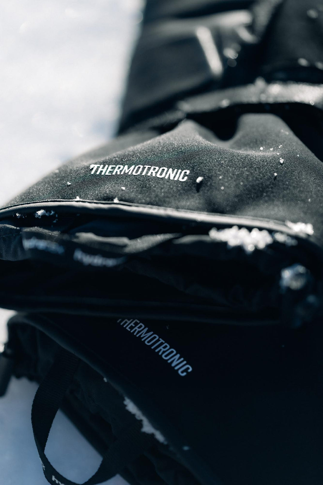 REV’IT! Liberty 2 H2O Men’s Heated Motorcycle Gloves in black, close-up Thermotronic detail.
