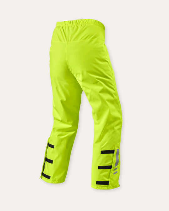 Rear view of REV’IT! Acid 4 H2O rain pants in neon yellow with reflective detailing