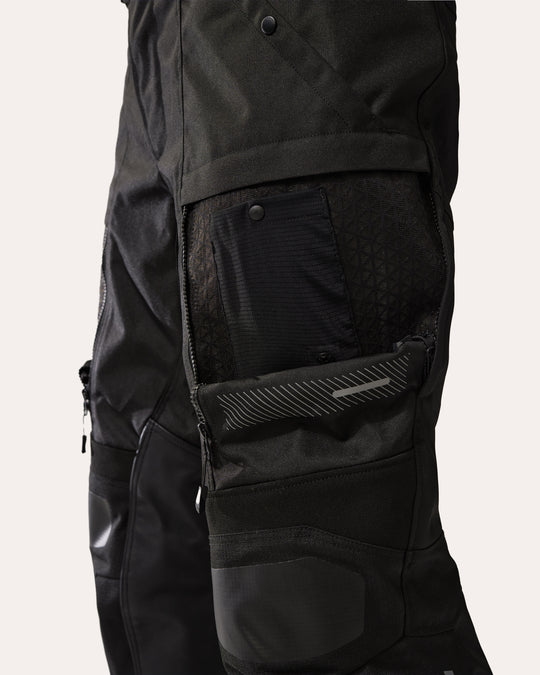 REV'IT! Sand 5 H2O black motorcycle trousers close-up – thigh ventilation panel open showing mesh lining