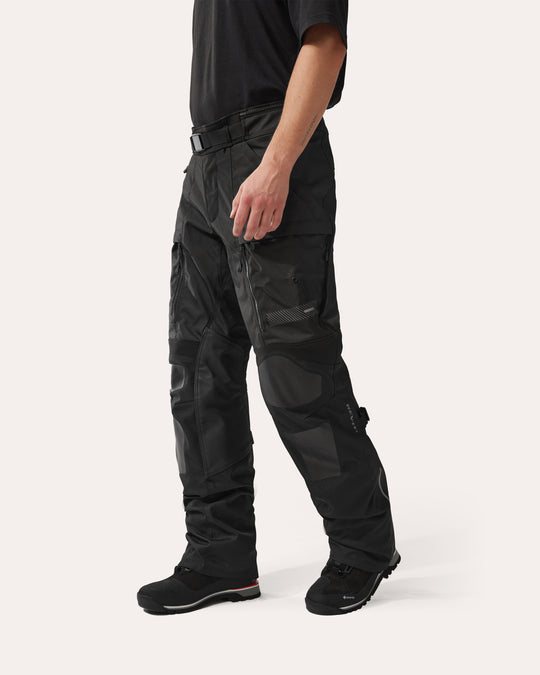 REV'IT! Sand 5 H2O black motorcycle trousers side view on model – waterproof adventure riding pants with CE protection