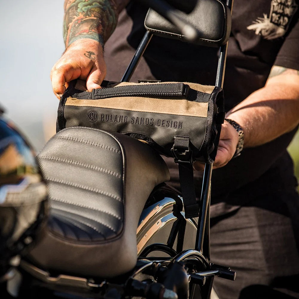 Roland Sands Design x Kriega Roam Tool Roll Ranger in brown mounted on motorcycle sissy bar outdoors