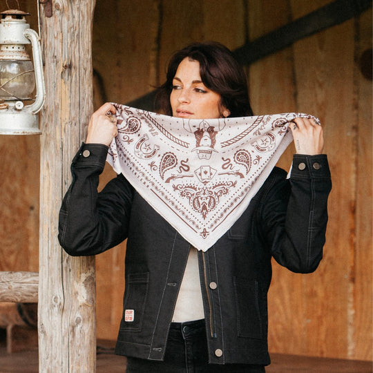 Rider holding up Wildust Sisters Best in the West Scarf — western-inspired motorcycle accessory