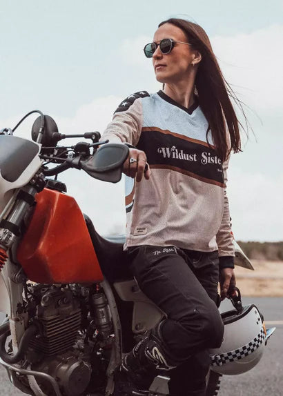 Front view of Wildust Sisters Classic Rider Mesh Jersey Cross in lifestyle riding scene