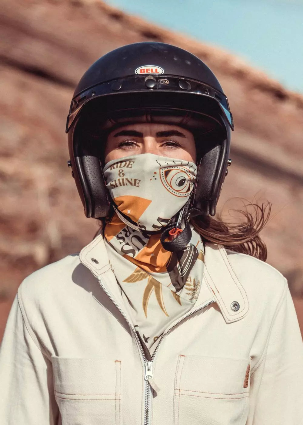 Rider wearing Ride & Shine Scarf as neck tube – khaki and ecru reversible print