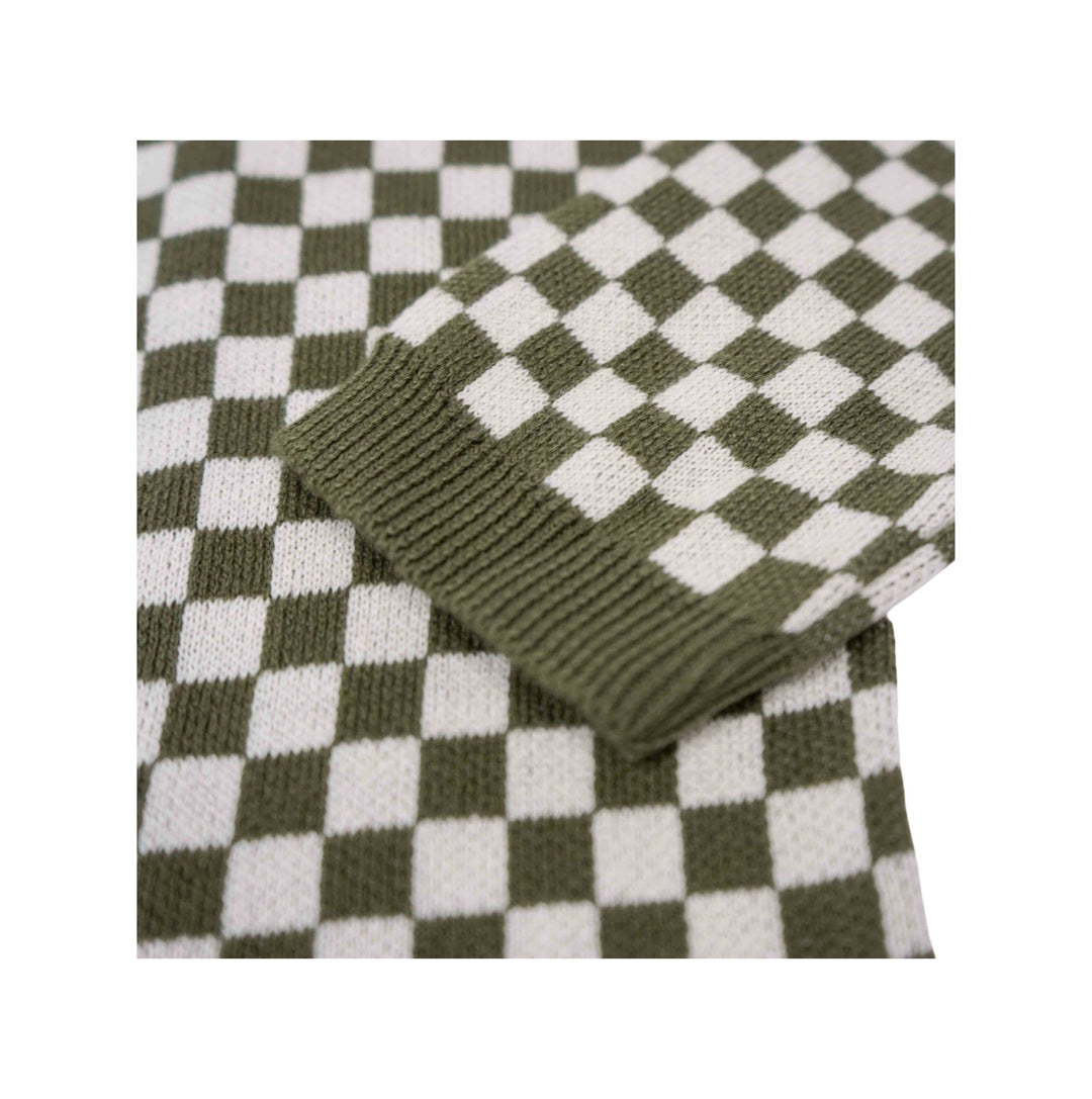 Close-up of the Wildust Sisters Vintage Racing Jumper in Khaki showing the chequered cotton knit and ribbed cuff
