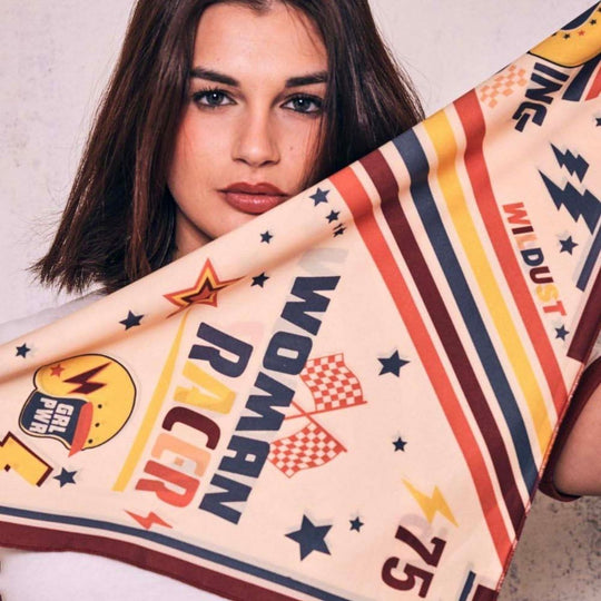 Wildust Sisters Pole Position motorcycle scarf folded close-up with racing graphics and stripes held by model