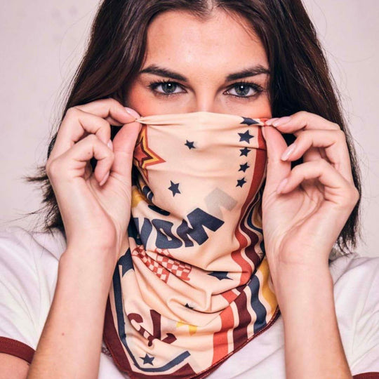 Wildust Sisters Pole Position motorcycle scarf worn as face covering with retro racing print close-up