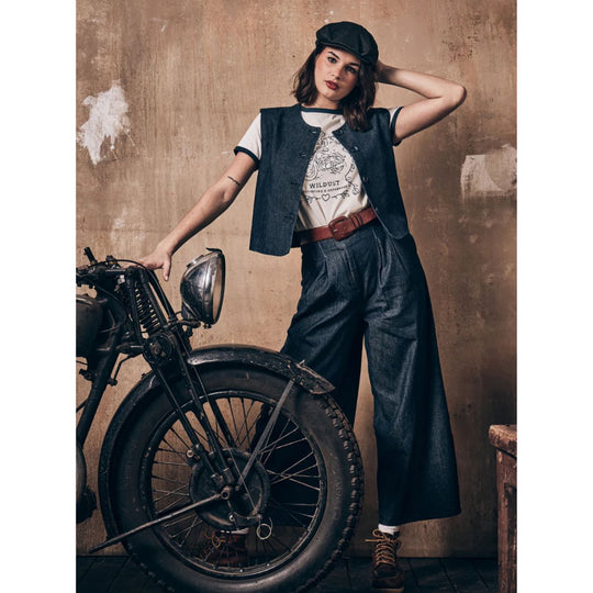 Wildust Sisters Riders Club t-shirt women’s lifestyle image with vintage motorcycle and denim vest styling