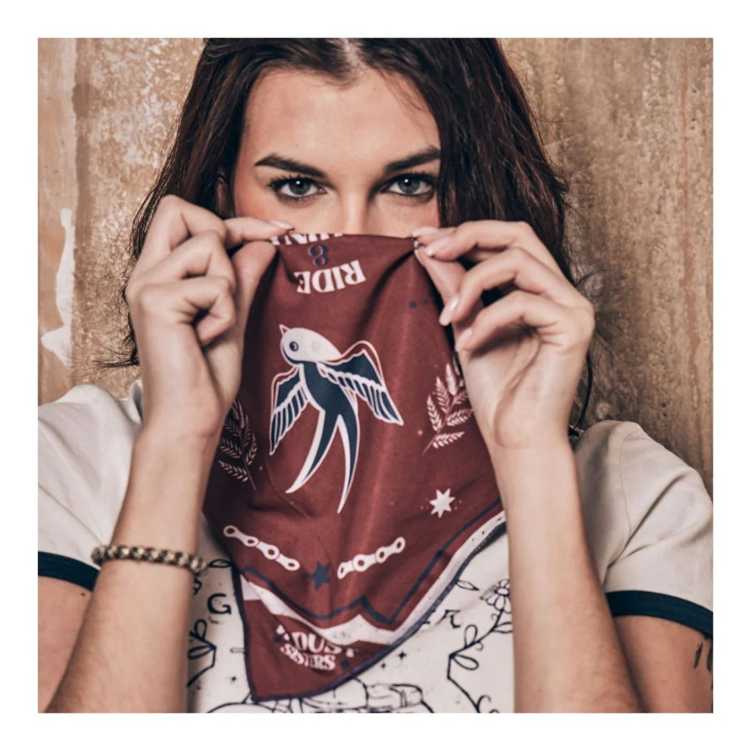 Wildust Sisters Victory motorcycle scarf brown graphic print worn face covering lifestyle image
