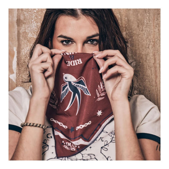 Wildust Sisters Victory motorcycle scarf brown graphic print worn face covering lifestyle image
